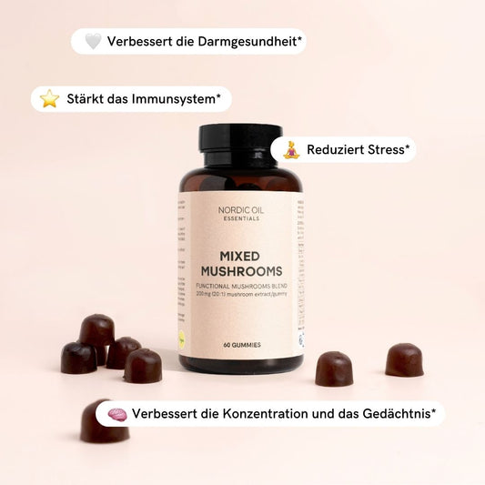 Flasche Nordic Oil Essentials Mixed Mushrooms Gummies mit braunen Gummis vor rosa Hintergrund