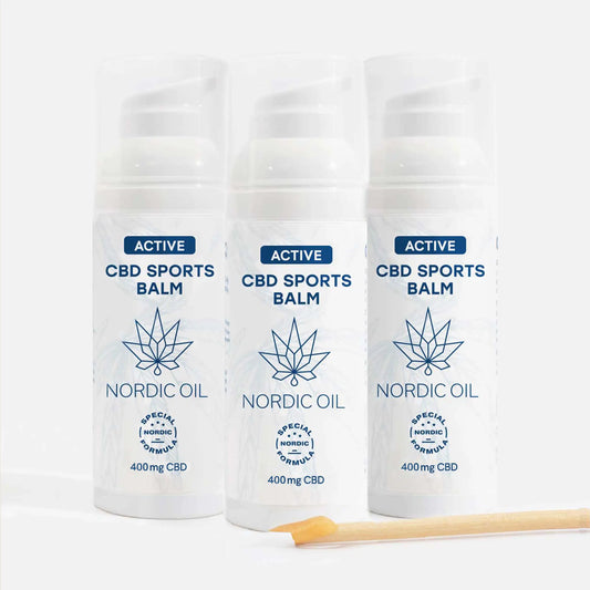 Drei weiße Nordic Oil Active CBD Sports Balm Flaschen mit Cannabispflanzen-Logo und 400 mg CBD
