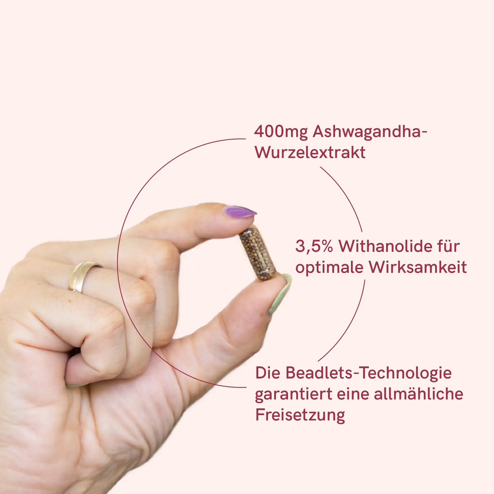 Frau hält Ashwagandha Kapsel mit Information: 400mg Ashwagandha-Wurzelextrakt; 3,5& Withanolide für optimale Wirksamkeit; Die Beadlets-Technologie garantiert eine allmähliche Freisetzung